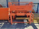 a large orange machine that is sitting on a pallet