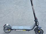 a scooter that is sitting in the parking lot
