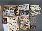 a box of assorted pins and magnets on a table