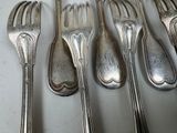 five forks and five spoons on a white table
