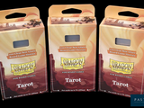 three boxes of tarot sitting next to each other on a black surface