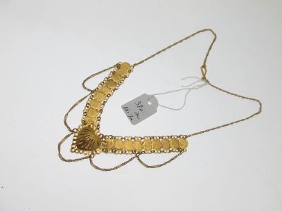 necklace with gold beads and a tag on a white surface