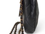 a black chanel bag with a chain hanging from it