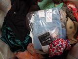 a suitcase full of clothes and other items on the couch