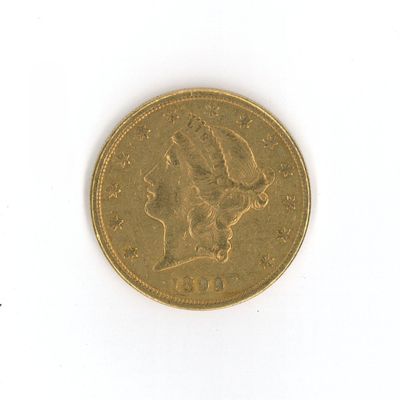a gold coin on a white surface with a white background