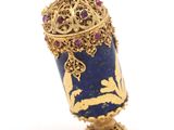 an image of a blue vase with a bird on top of it