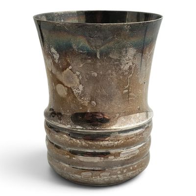 a silver vase sitting on top of a white table