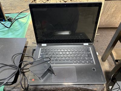 a laptop that is sitting on a table with a charger