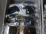 several pairs of sunglasses are in a box on a table