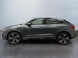 a grey audi qx parked in a parking lot
