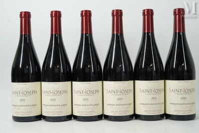 six bouteilles de vin sont alignées sur une table