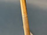 a close up view of a wooden pole with a stick sticking out of it
