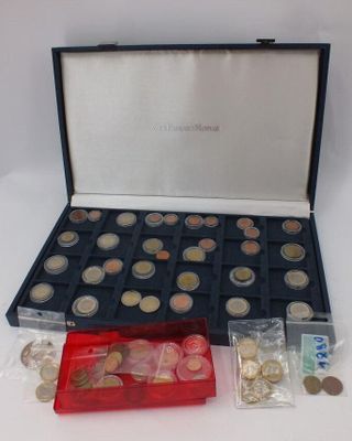 a box of coins and a plastic container with coins in it