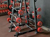 a gym area with a rack of dumbs and weights