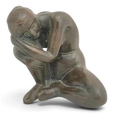 statue of a kneeling man holding his head in his hands