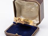 a small box with a gold ring inside of it