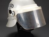 a close up of a helmet on a black stand