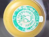 a close up of a yellow frisbee with a sticker on it