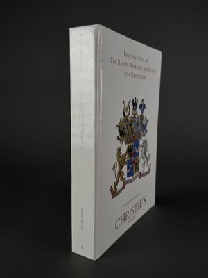 a white book with a picture of a coat of arms on it