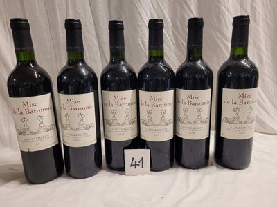 six bottles of wine are lined up on a table