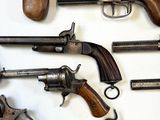 a lot of guns that are on the wall