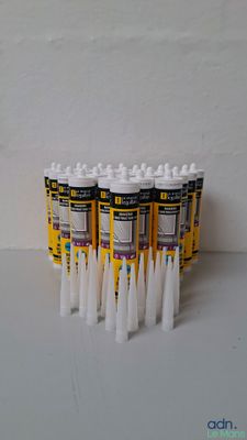 six tubes of toothpaste on a white table