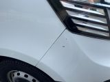 a close up of a white car with a black stripe on it