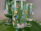 three green glass vases on a green tray