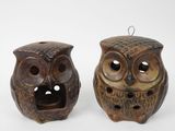 two ceramic owls that are sitting next to each other