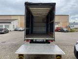 the back end of a truck with a flat bed in a parking lot