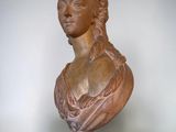 a bust of a woman on a pedestal on a white background