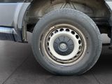 a close up of a truck tire with a cat sitting on it