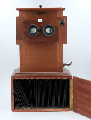 an old wooden camera with two lenses and a wooden case