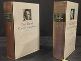 two books on a table with a picture of a man in a suit