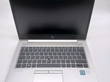 an image of an open laptop computer sitting on top of a white table