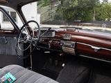 dashboard of an old car with a leather seat and dashboard buttons