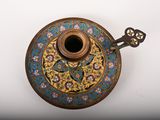 a gold and blue vase with a key on it