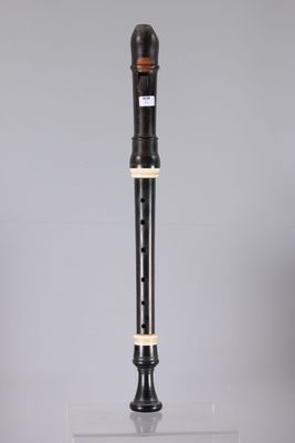 a black and white flute sitting on top of a glass table