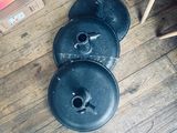 a person standing on a wooden floor next to a bunch of pots and pans