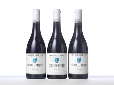 three bottles of wine sitting on top of a table