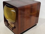 a small wooden box with a yellow glass in it