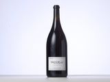 the bottle of wine is sitting on the table with a white background