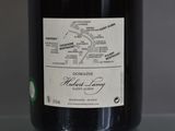 a bottle of wine sitting on a table with a map on it