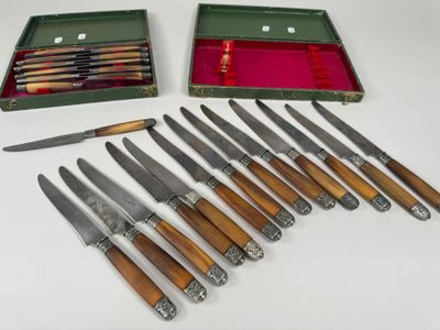 several knives and a box of knives sitting on a table