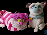 two stuffed animals sitting next to each other on a black background