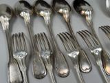 a lot of silver spoons and forks on a table