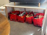 a couch and a table in a room with red bags on the floor
