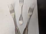 three forks and two spoons on the table