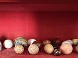 many different vases on a shelf in a red room