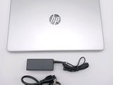 a laptop with a charger attached to it on a table